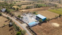 Stone yard and workshop compound beside cultivated fields