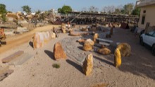 Open display yard with carved stone pieces and paving samples