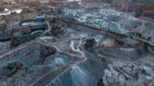 Twilight view across active quarry faces and haul tracks