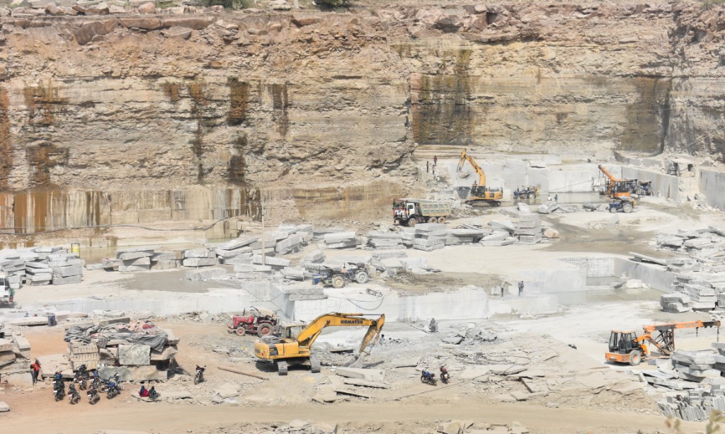 Open-pit quarry with machinery and stone blocks