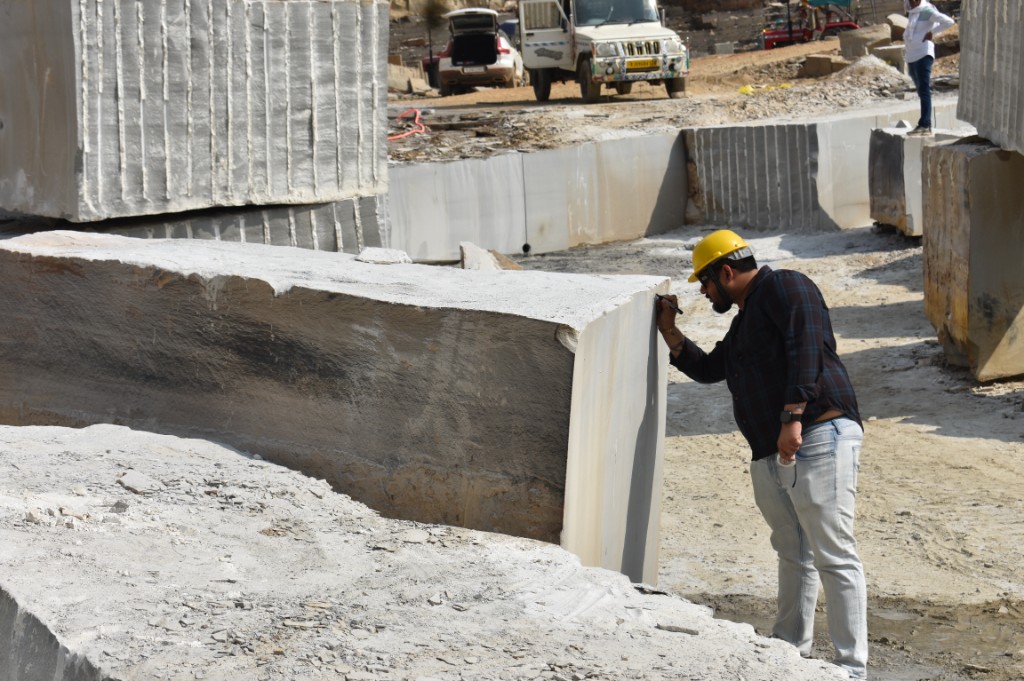 Worker inspecting stone block