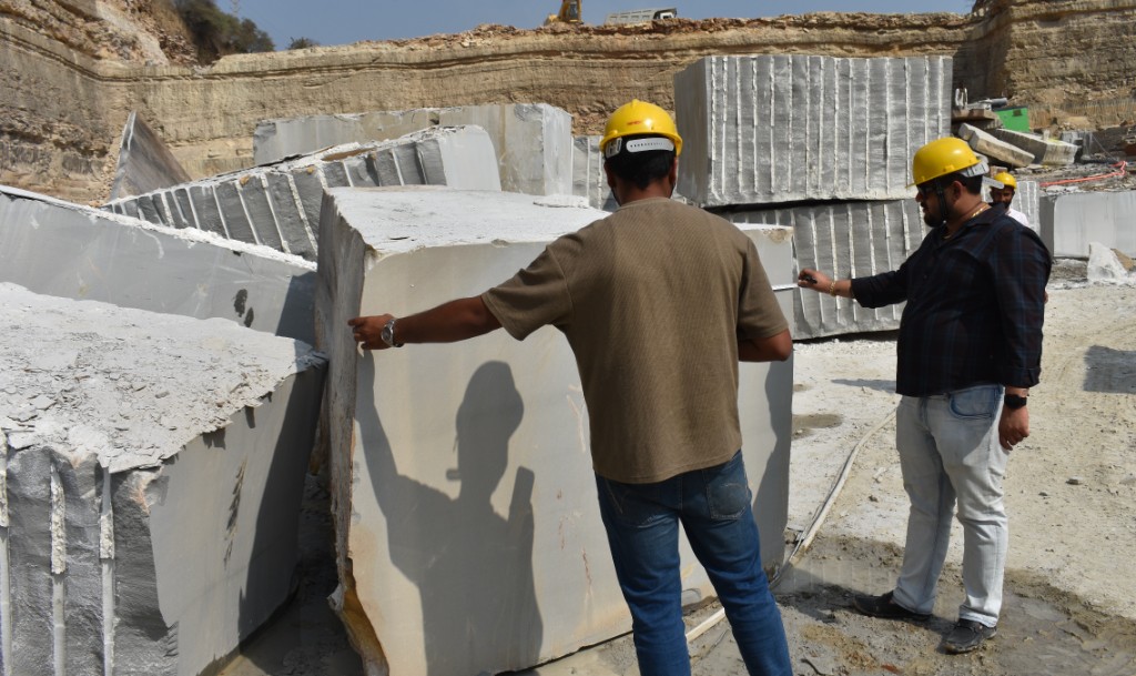 Workers measuring stone blocks