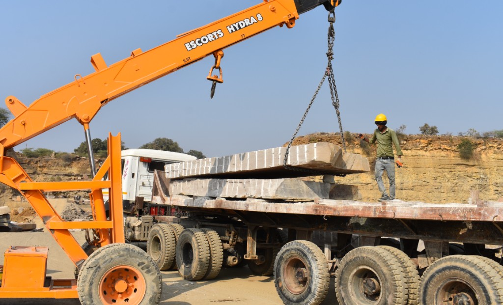 Crane lifting stone slab