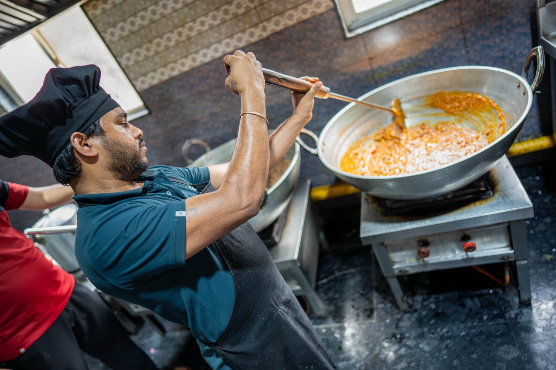 Chef cooking in the Vyanjanam kitchen