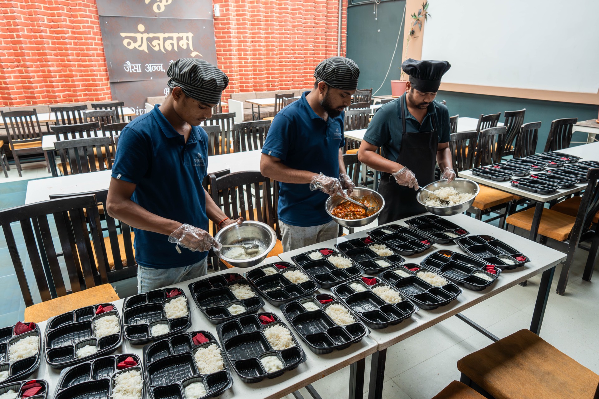 Vyanjanam team arranging packed meals for service