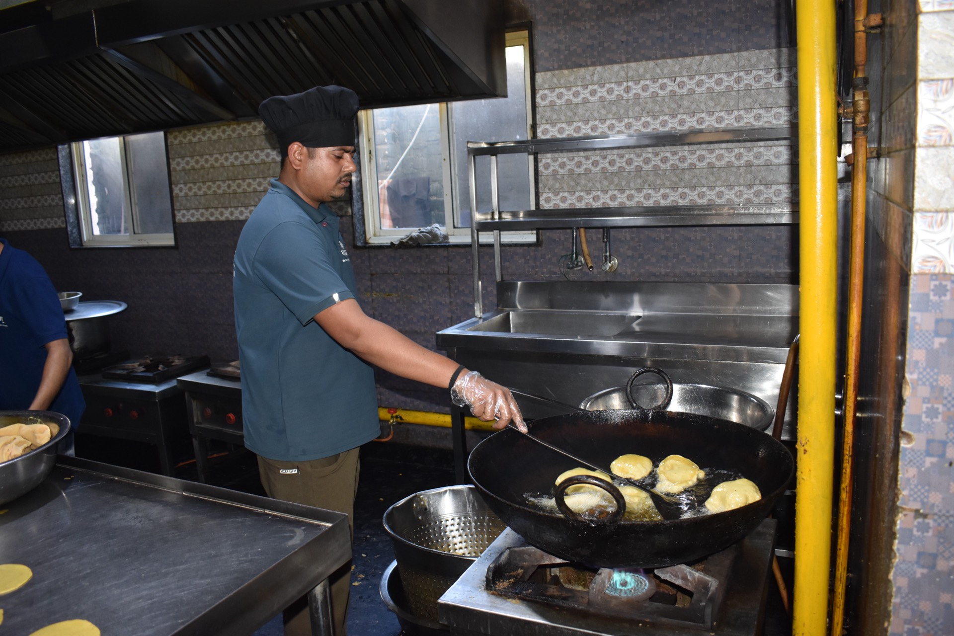 Fresh puris frying in the Vyanjanam kitchen